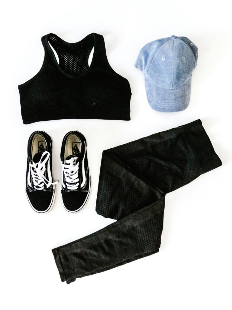 Flat lay of activewear sports bra, leggings and sneakers to resell