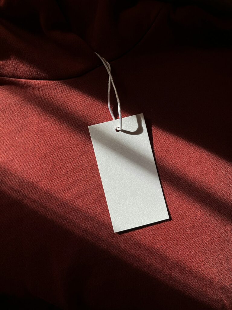White price tag hanging from red fabric