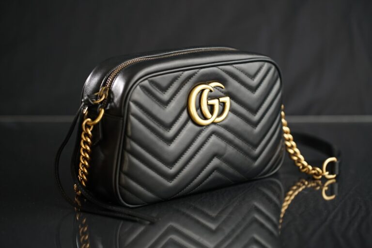 Black designer quilted handbag with a gold chain for resale