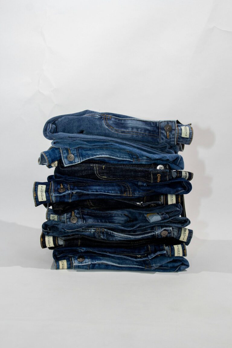 Neatly folded stack of denim jeans ready to list for resale