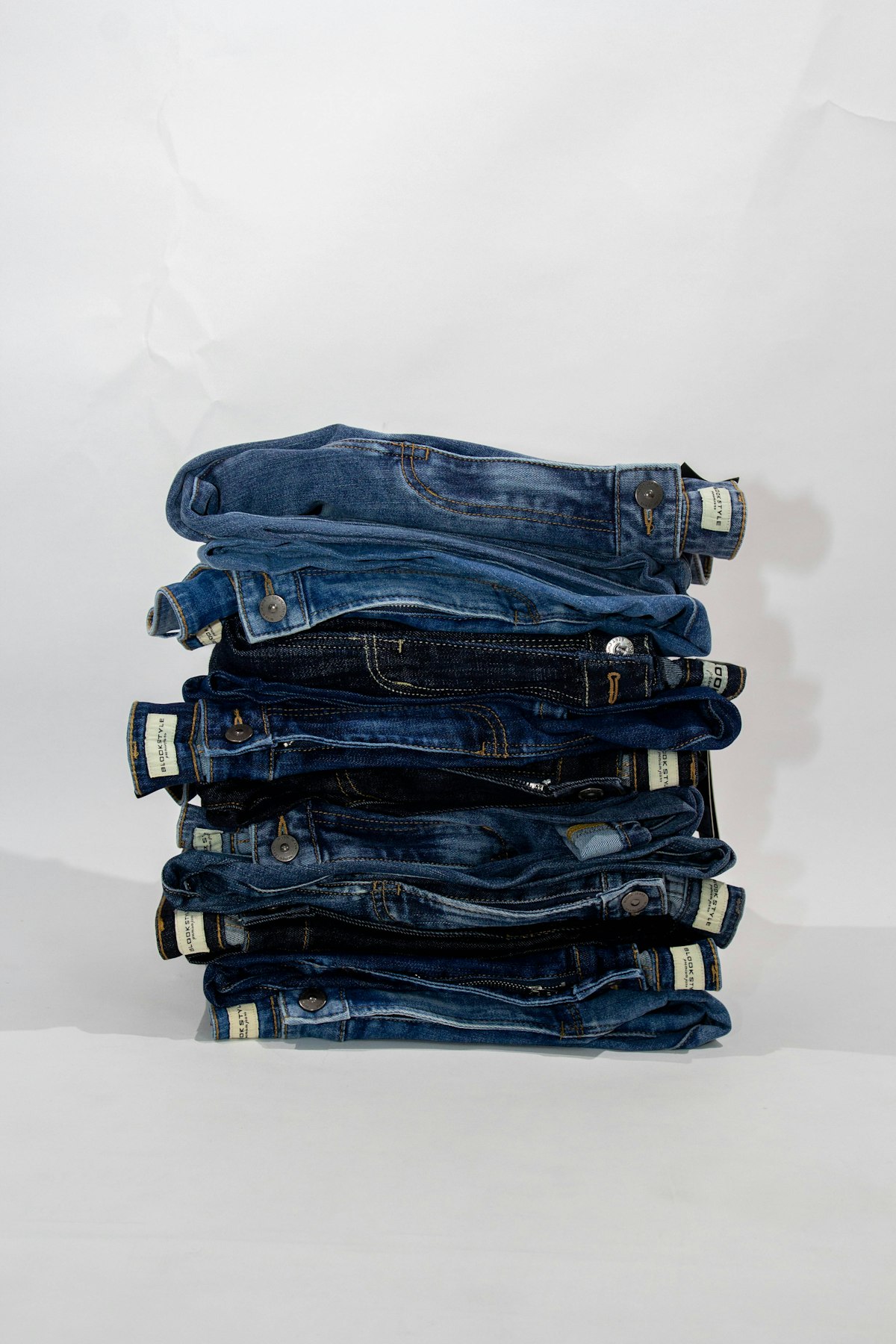 Neatly folded stack of denim jeans ready to list