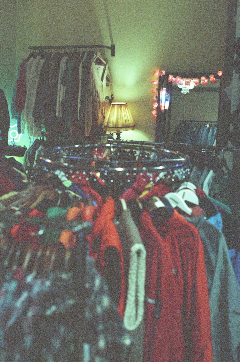 Vintage clothing hanging on racks in a resale shop