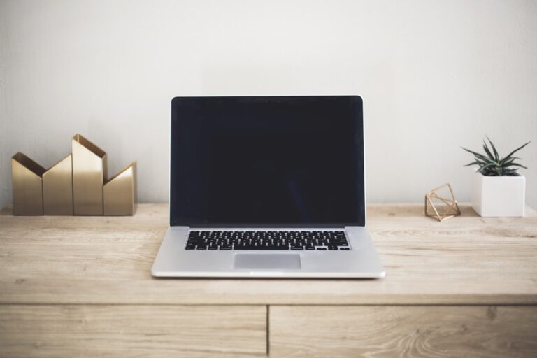 Minimal desk with a laptop for writing online listings
