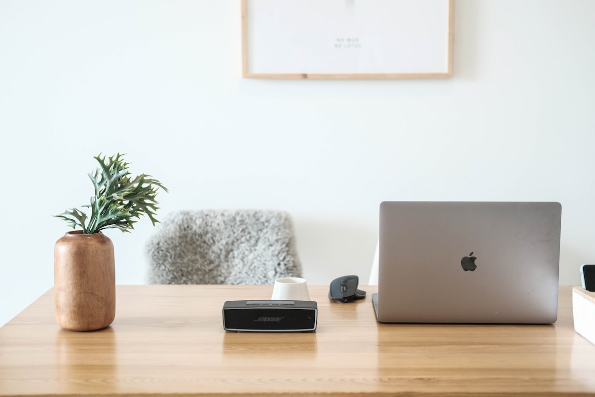 Minimal desk with a laptop for managing online listings