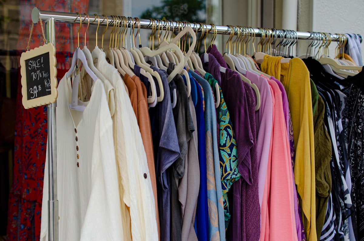 Rack of secondhand shirts organized for resale