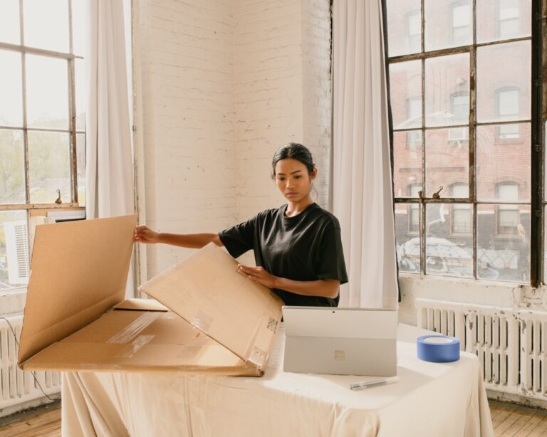 Open cardboard shipping box on a desk ready for packing an order